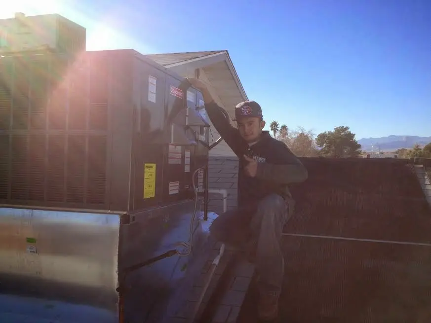HVAC technician performing HVAC Inspection on a rooftop unit in Oak Bluffs